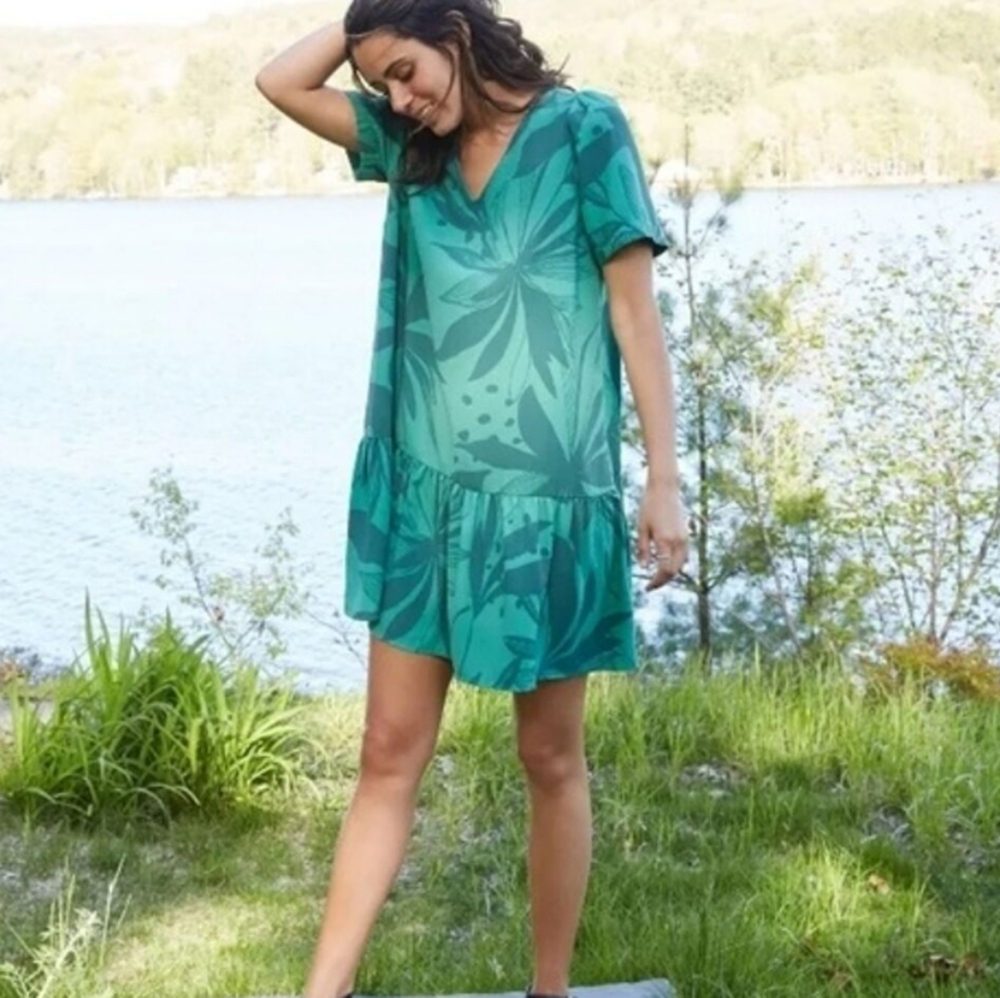 A new day shift green dress with palm print and ruffle hem.  Short sleeves and v